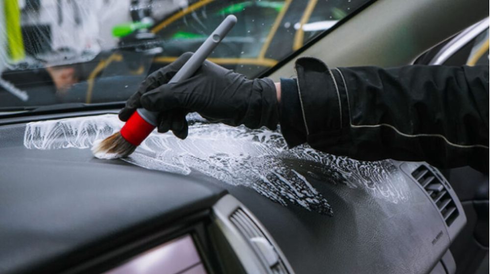 Interior car detailing cost showing professional cleaning of seats, dashboard, and carpets